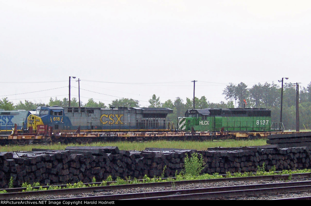 CSX 618 & HLCX 8137 in the ready field in a light rain